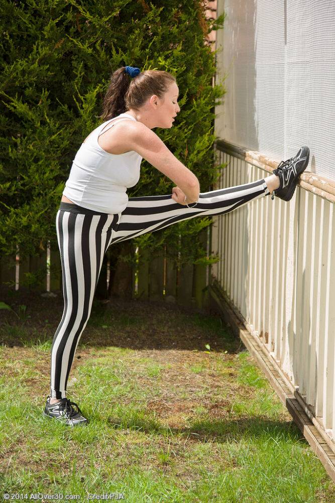 Athletic middle-aged woman strips naked in kitchen after working up a sweat - #12