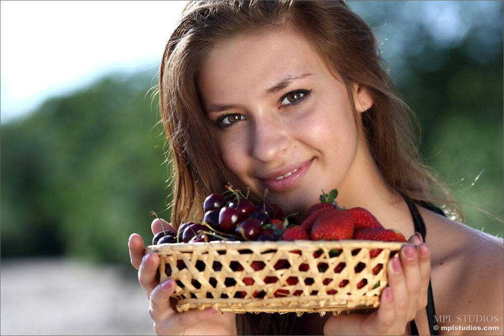 Nice teen girl puts down a basket of fruit and strips naked on a sandy beach - #10