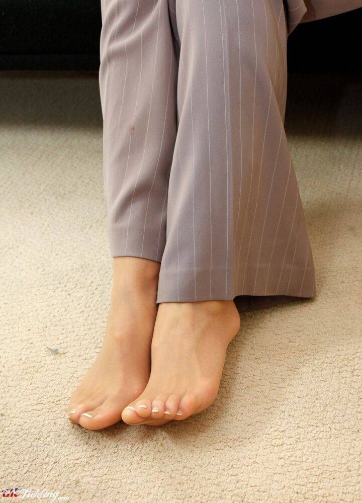 Blonde female Chacha shows her hose clad feet in a business suit - #11