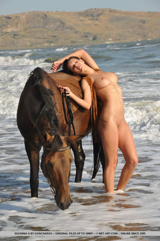 Big titted Suzanna A shows shaved twat posing naked on beach with horse - #9