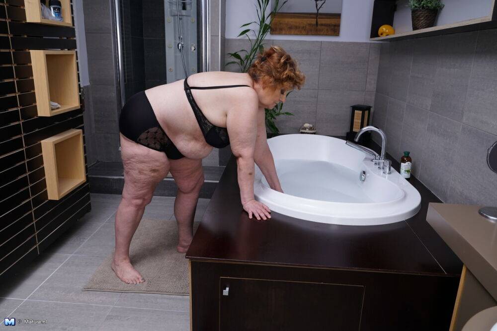 Obese older woman sinks into a bubble bath before unzipping her toy boy - #16