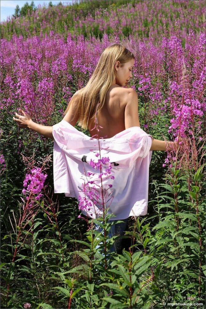 Solo girl takes off her clothes as she strolls thru a patch of fireweeds - #4