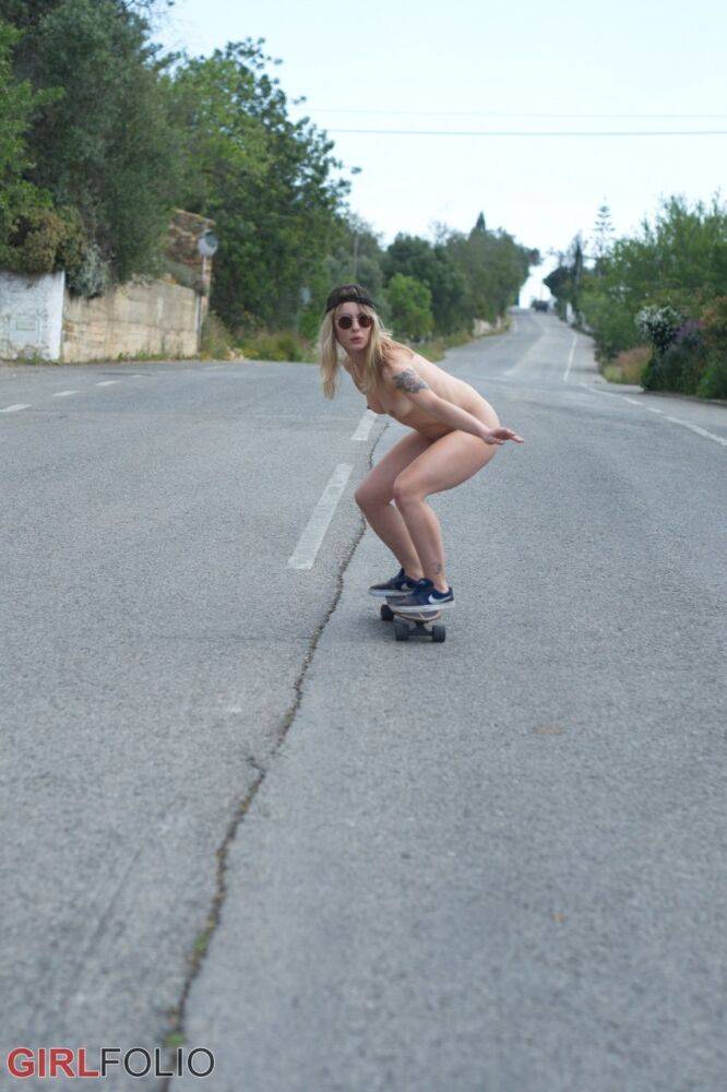 Blonde skater girl Pippa Doll strips naked before boarding down a paved street - #4