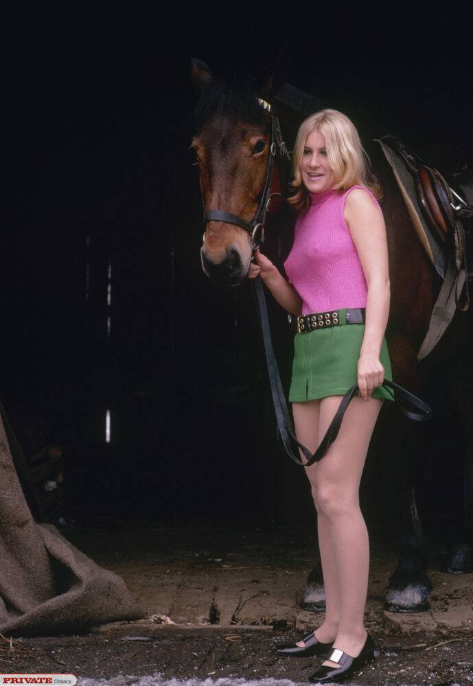 Blonde female reveals thigh and ass while mounting her horse in a short skirt - #2