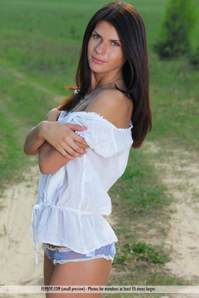 Pretty brunette Katrina gets completely naked on a dirt path in a field - #9