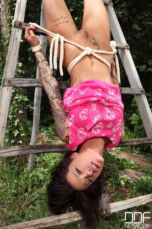 Tattooed girl Nikita Bellucci is tied to a ladder before being forced into sex - #11