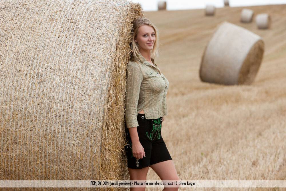 Beautiful blonde teen Carisha strips naked next to a round bale of hay - #4