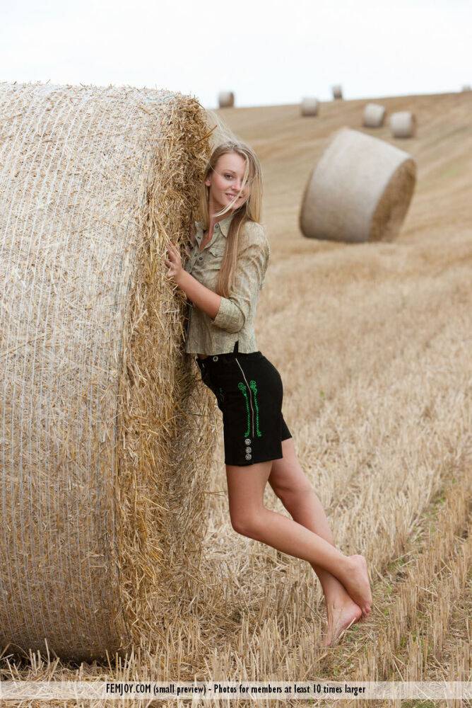 Beautiful blonde teen Carisha strips naked next to a round bale of hay - #14