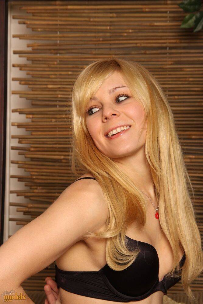 Young blonde Emma makes her nude debut while alone on a couch - #13