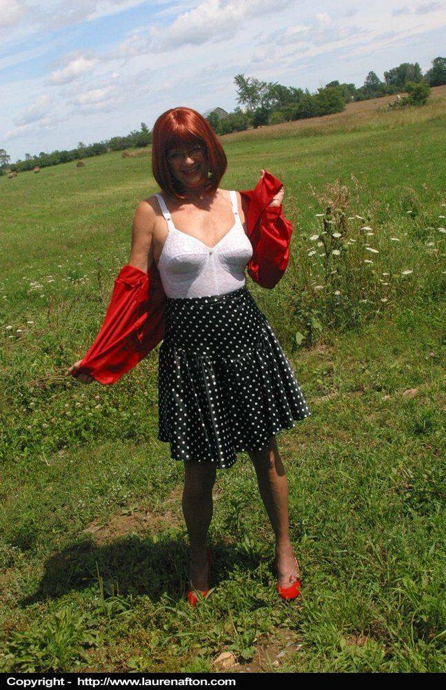 Older redhead Lauren models a retro girdle and nylons in a field - #3