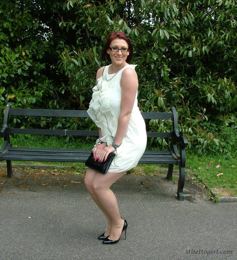 Thick woman in glasses shows off her stiletto heels on a park bench - #12