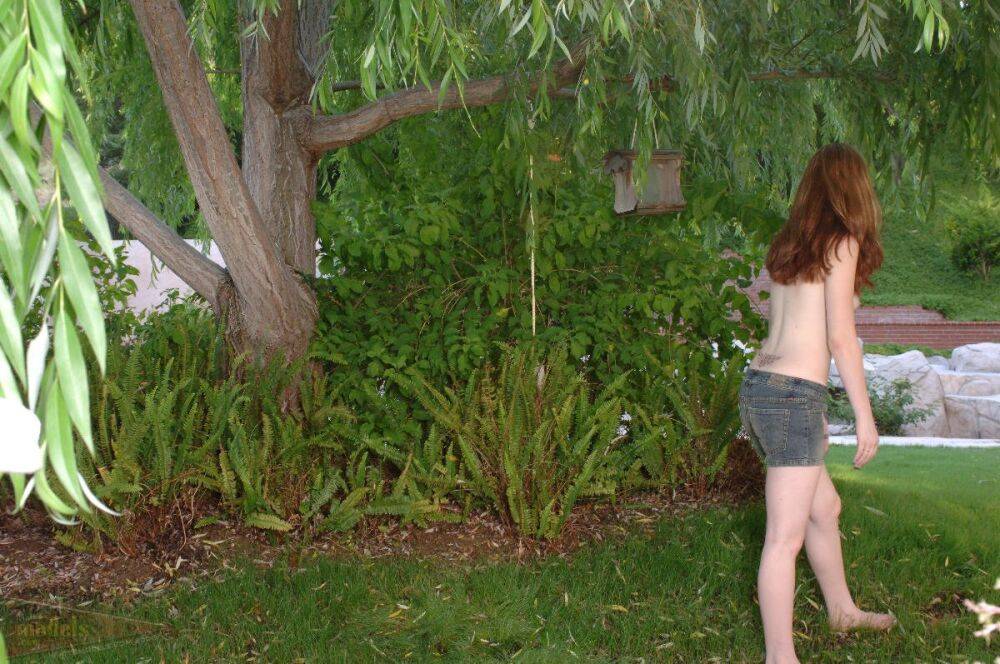 Redhead amateur Ruby Flame sports a close-up of her bald pussy in the yard - #9