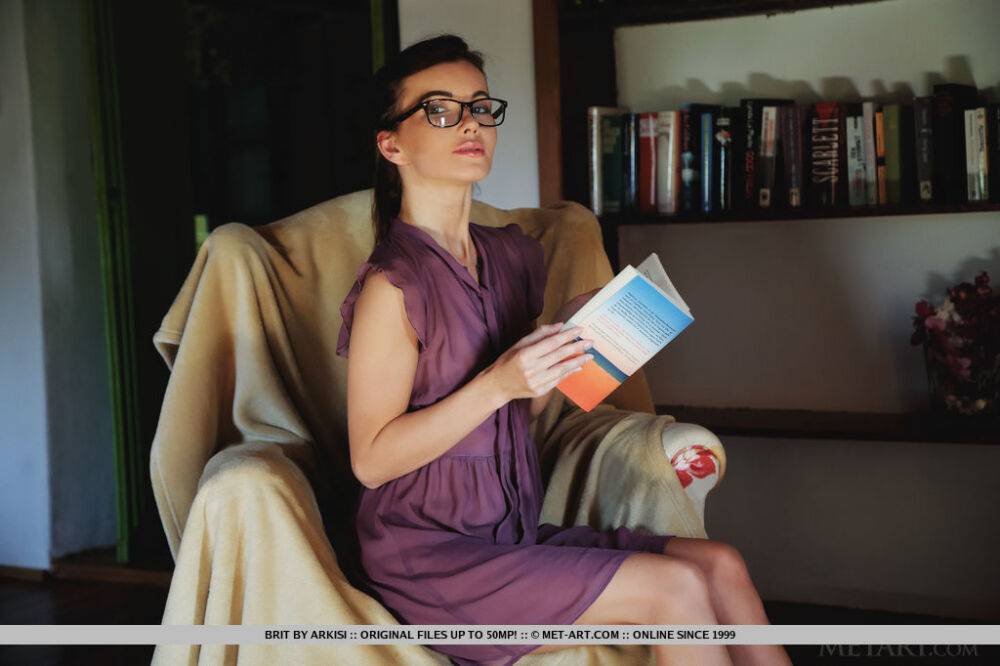 Thin teen takes off her glasses before modeling naked after reading in a chair - #7