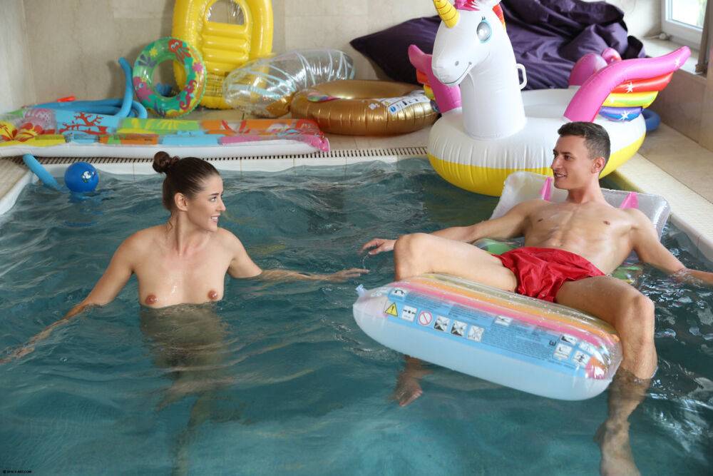 Nude beauty teases her man friend while he chills on an air mattress in a pool - #7