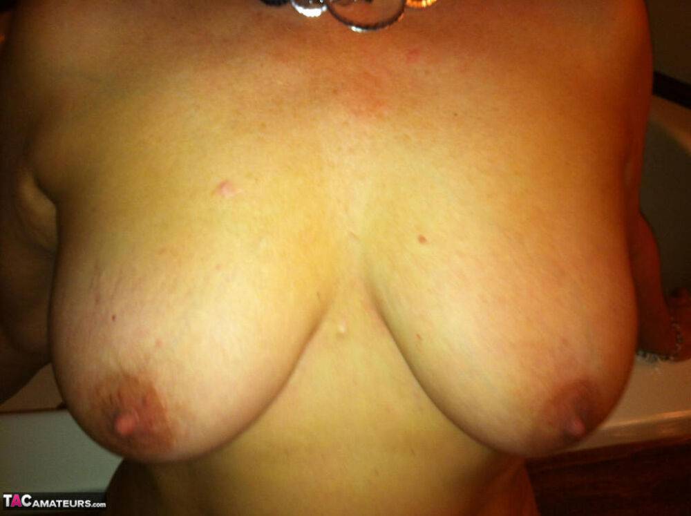 Mature woman Busty Bliss plays with her big tits after getting naked - #9