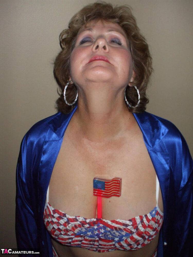 Older amateur Busty Bliss sets her natural tits free of a USA themed bikini - #12