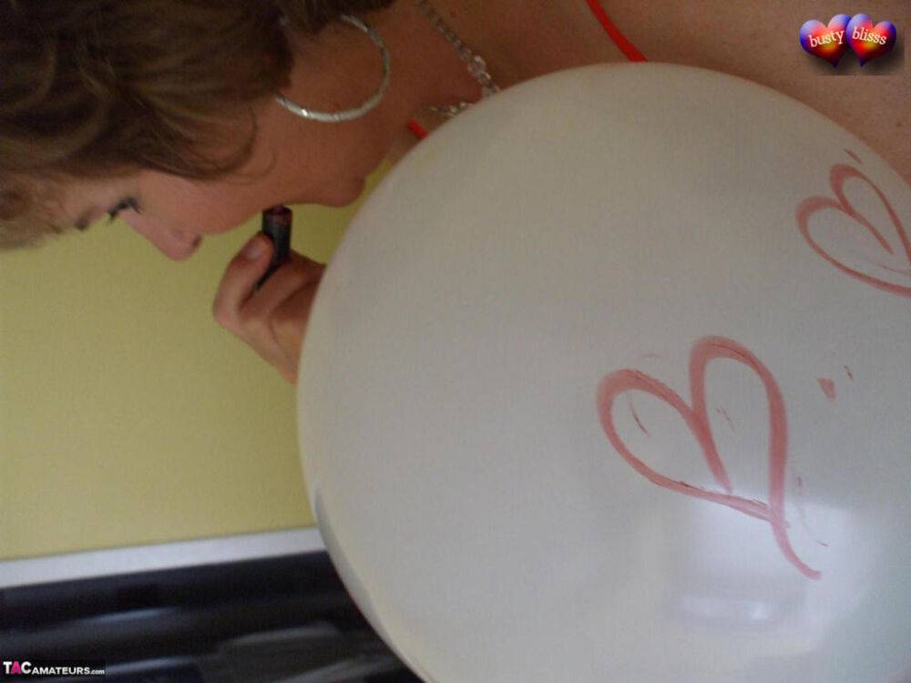 Mature woman Busty Bliss goes topless on her bed while playing with balloons - #4