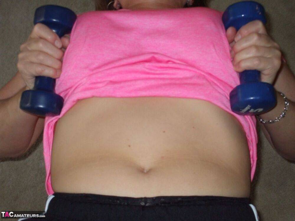 Mature woman Busty Bliss exposes her natural boobs while working out at home - #7