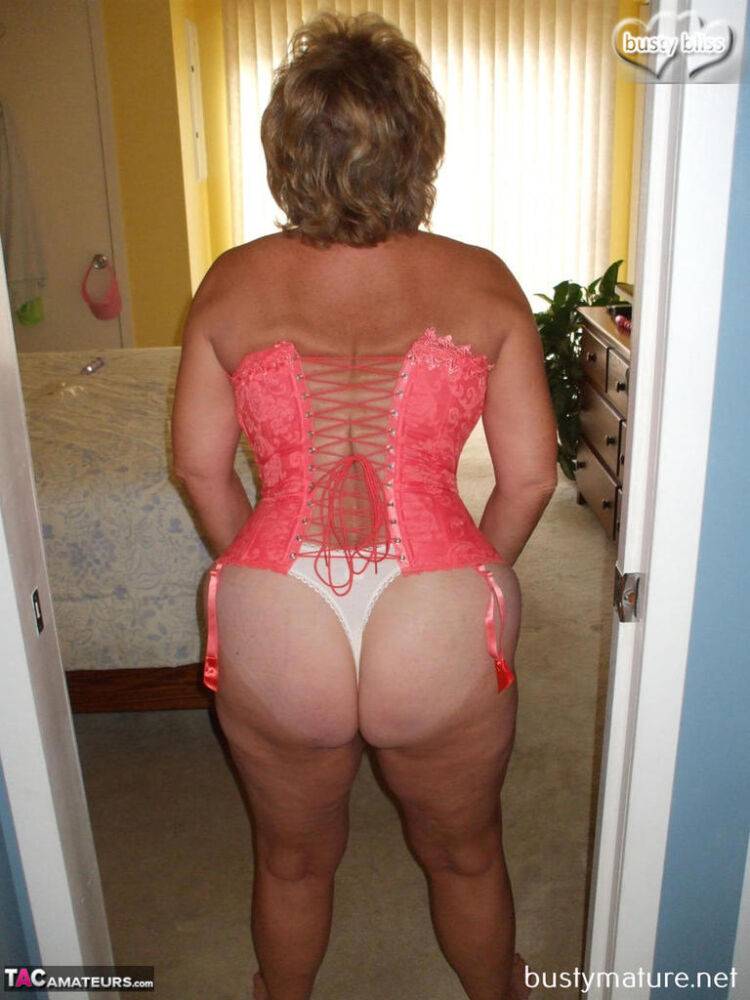 Mature amateur Busty Bliss models a laced up corset and thong in her bare feet - #13