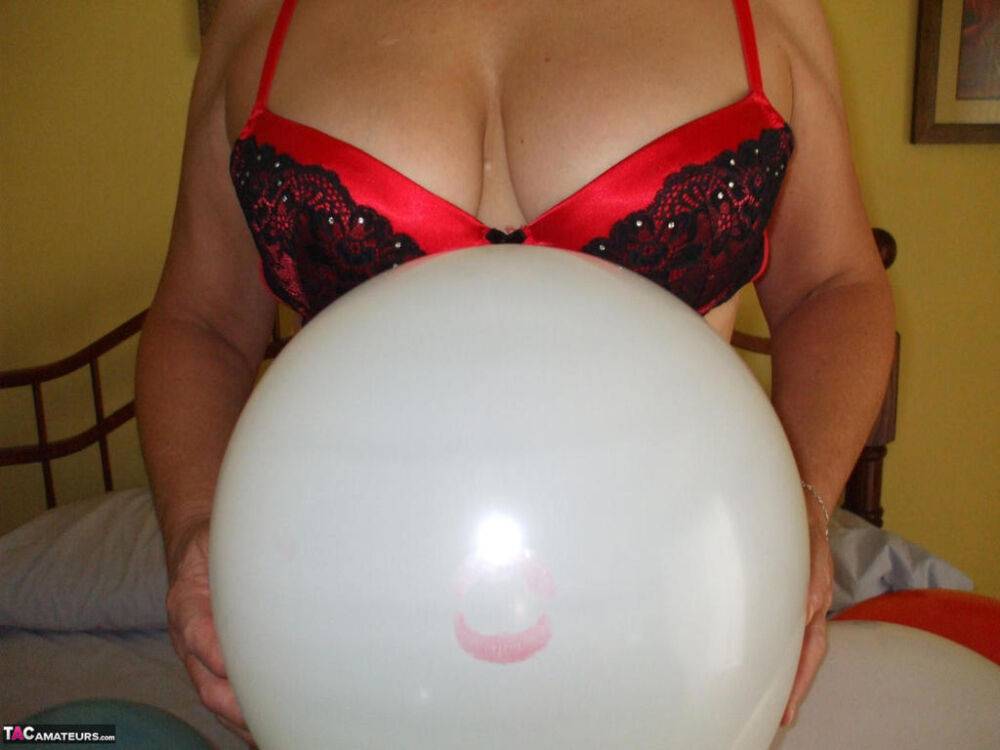 Older lady Busty Bliss plays with balloons before uncupping her natural tits - #10