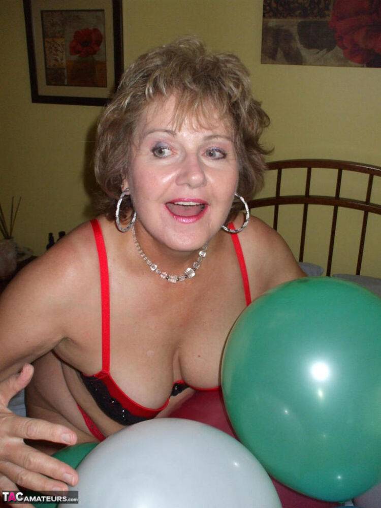 Older lady Busty Bliss plays with balloons before uncupping her natural tits - #7