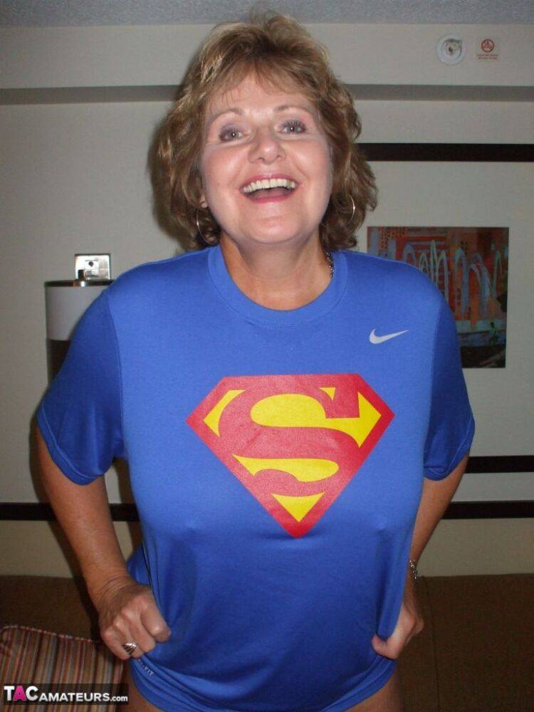 Older amateur Busty Bliss looses her big tits from a Superman T-shirt - #6