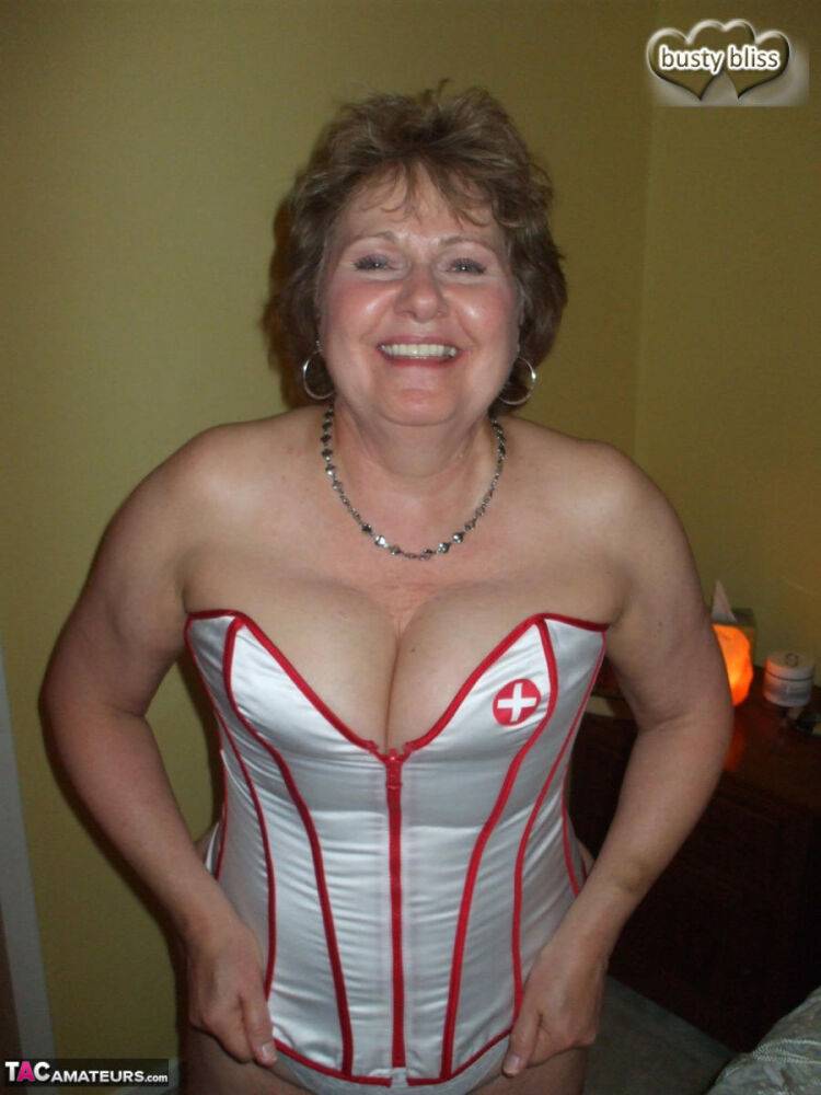 Mature woman Busty Bliss dons a collar before giving head in a corset - #12