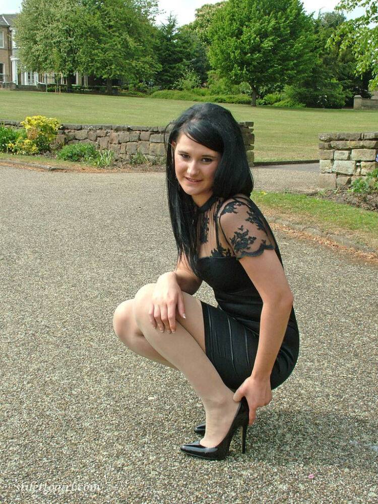 Clothed brunette female models her new black pumps in hosiery - #3