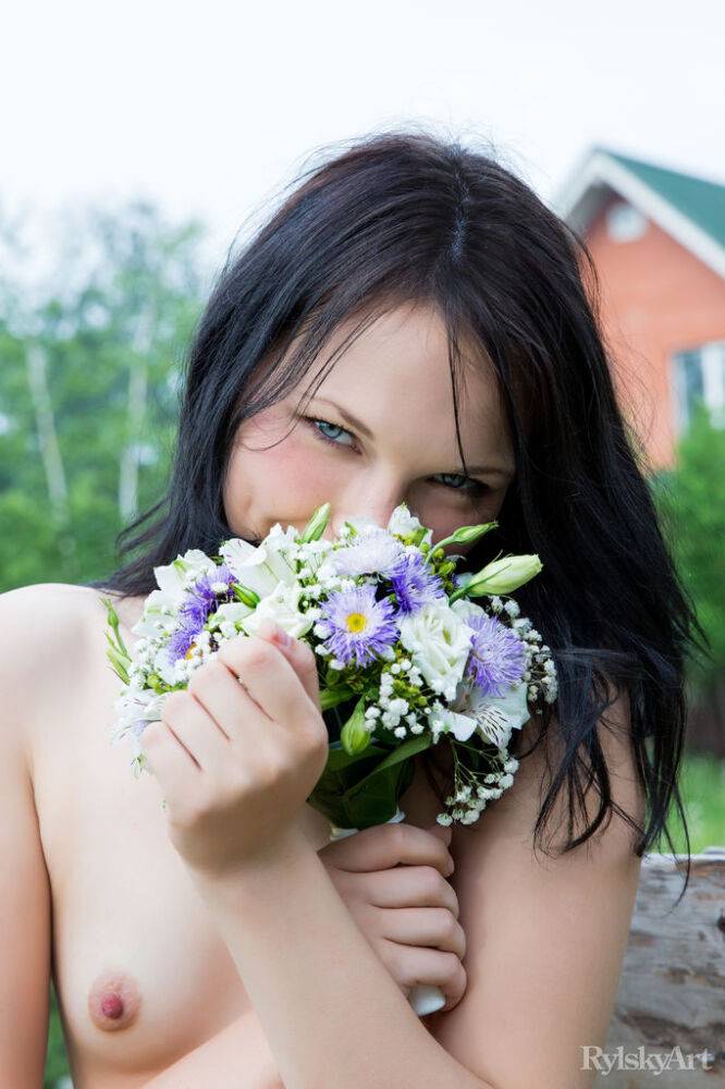 Petite teen Yvonne models totally naked on a wooden chair in the garden - #1