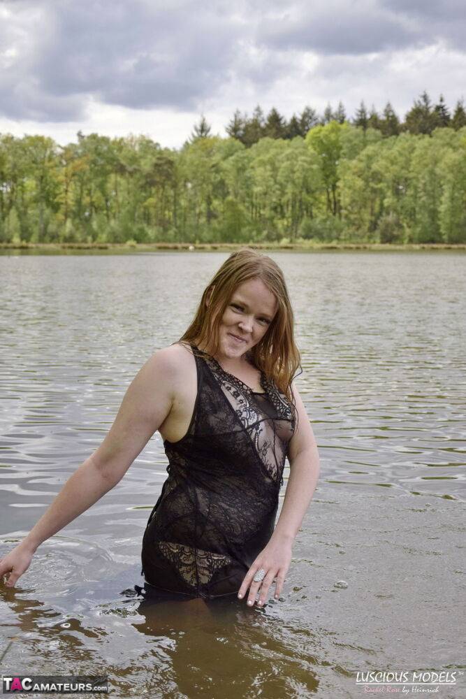 Redheaded amateur Luscious Models wades into a body of water in lingerie - #2