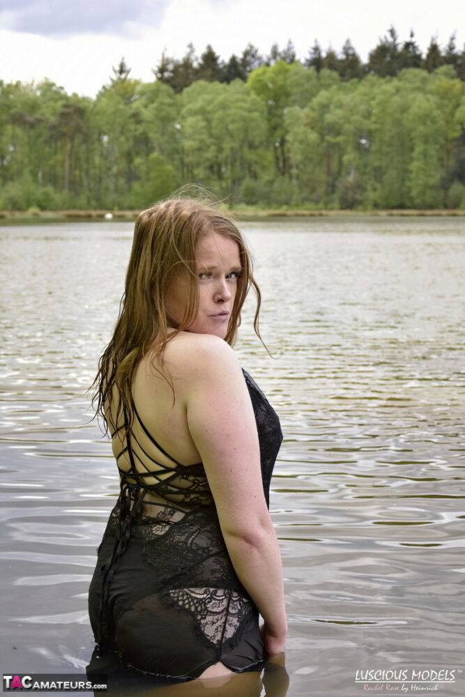 Redheaded amateur Luscious Models wades into a body of water in lingerie - #6