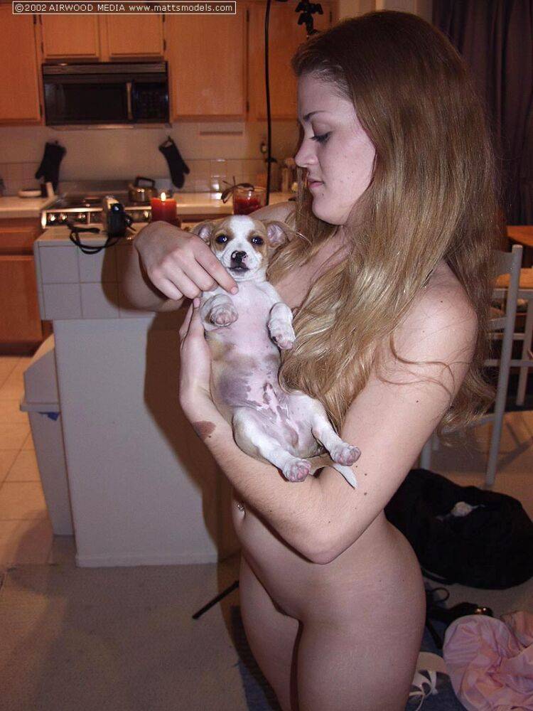 Redhead amateur Britney holds a puppy in her arms while completely naked - #7