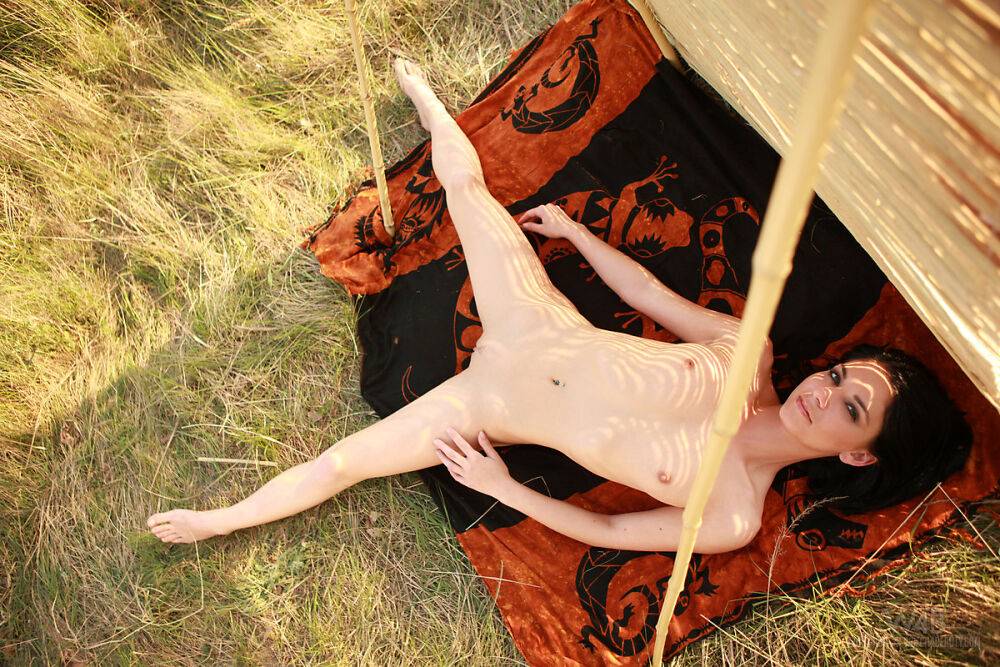 Totally naked teen Fiva models by herself on a spread out blanket - #16