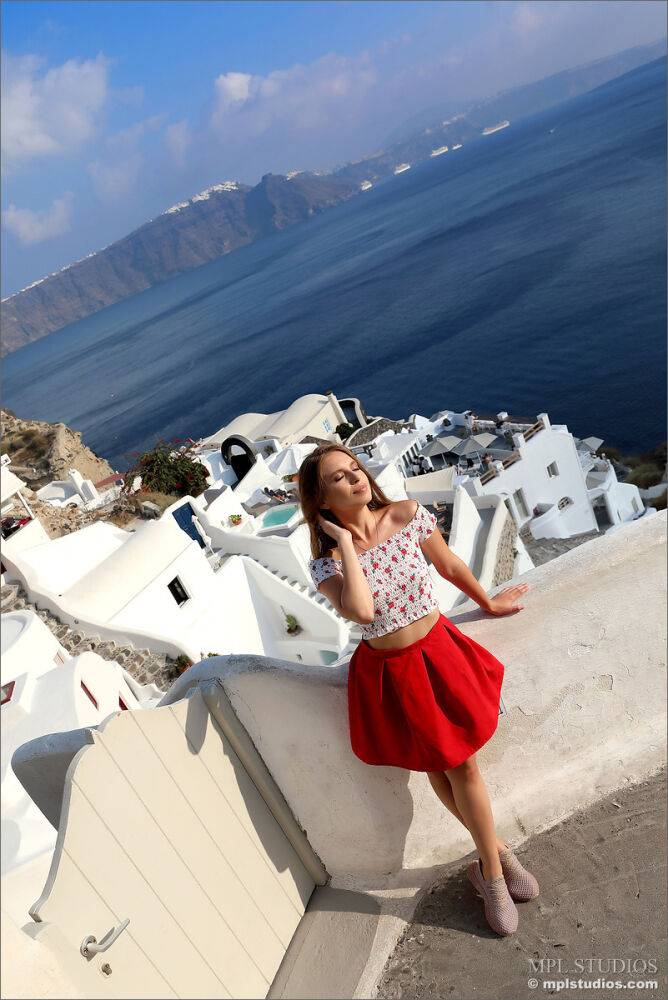 Pretty girl models fully clothed in a red skirt while on vacation - #3