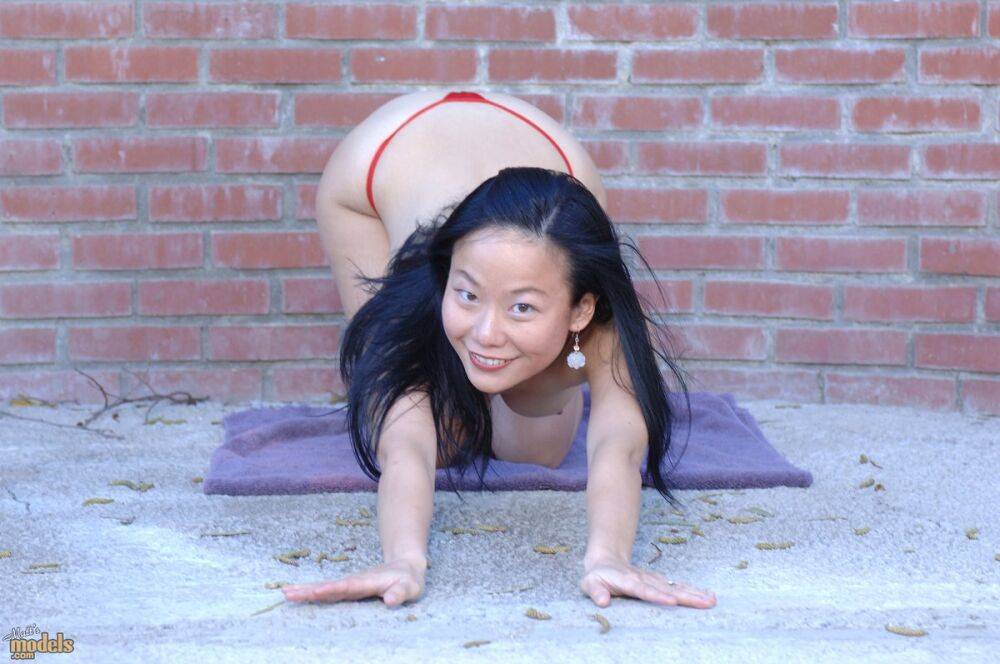 Asian first timer Niya Yu slips off her dress to get naked afore a brick wall - #10