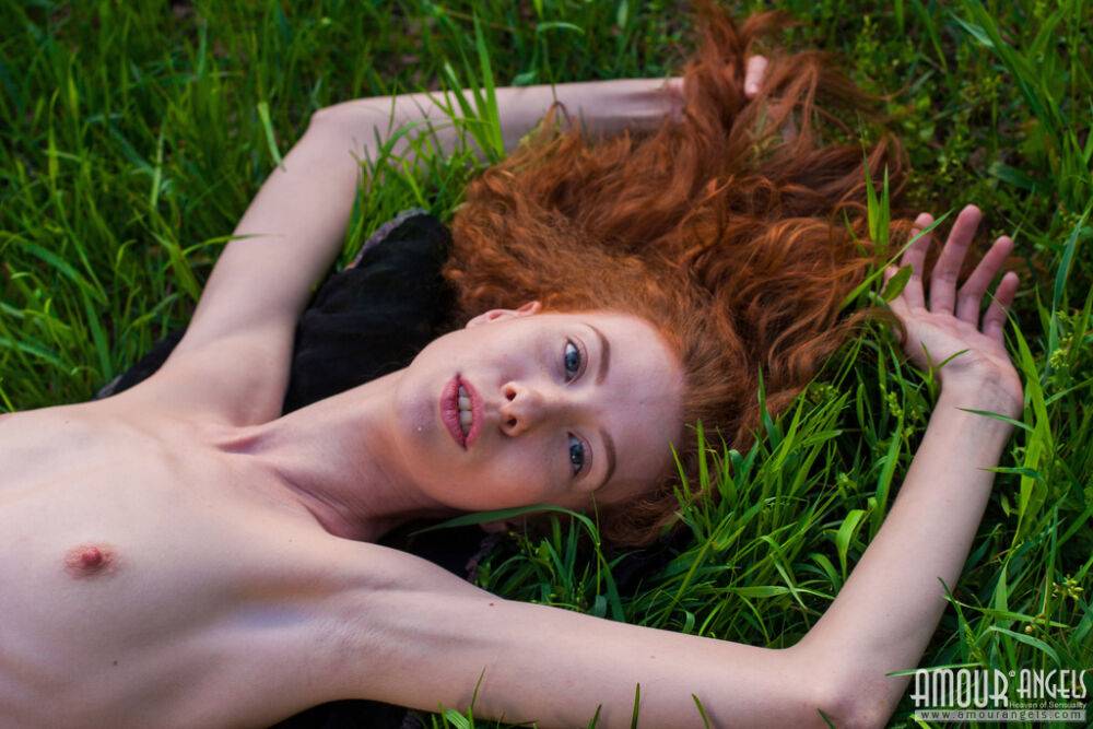 Thin redhead Veronika models totally naked on a blanket in a lush meadow - #7