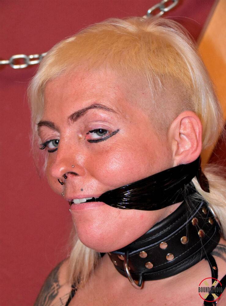 Tattooed blonde Hanka models various gags while cuffed and chained - #14