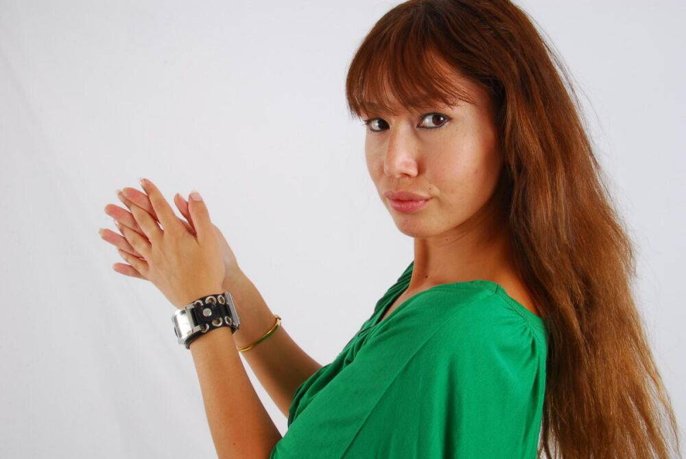 Redheaded Asian girl Evita models a Guess style cuff watch during SFW action - #4