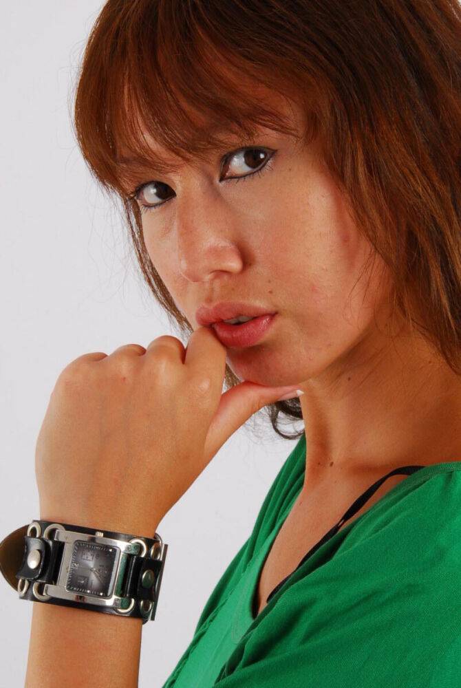 Redheaded Asian girl Evita models a Guess style cuff watch during SFW action - #6