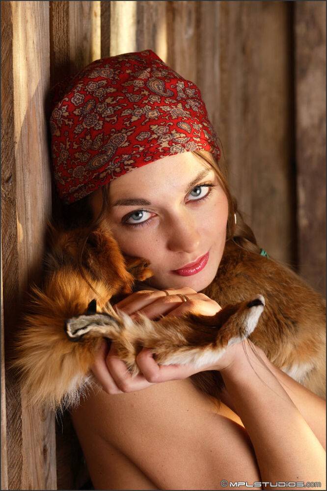 Adorable farm girl models naked in a barn with a fox draped around her - #6