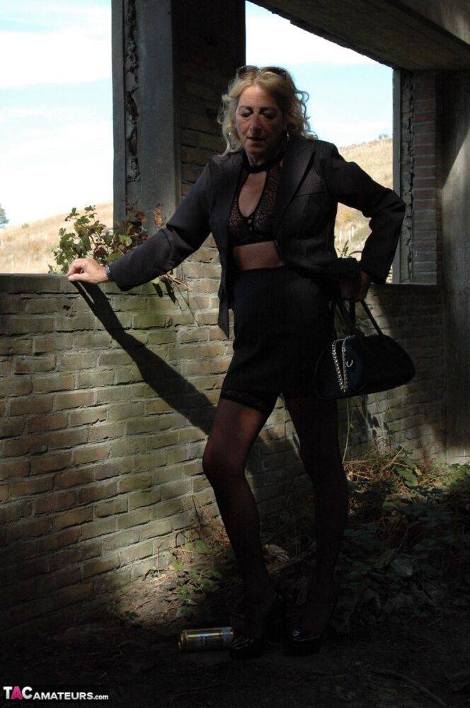 Mature blonde Kyras Nylons models stiletto heels in hosiery and a black skirt - #10