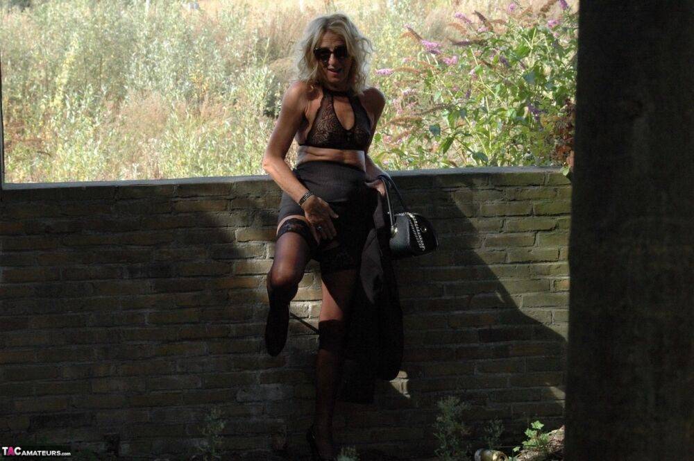 Mature blonde Kyras Nylons models stiletto heels in hosiery and a black skirt - #3