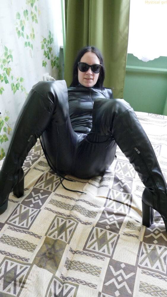 Dark haired amateur models a leather catsuit while wearing dark sunglasses - #14