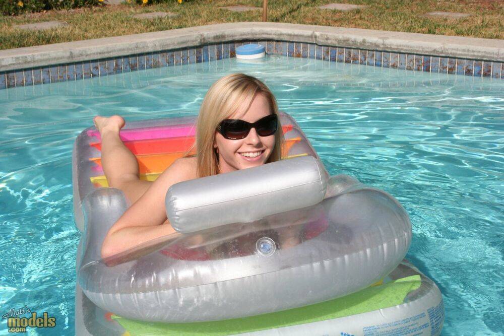 Blonde amateur Kara lounges on an air mattress in sunglasses only - #10