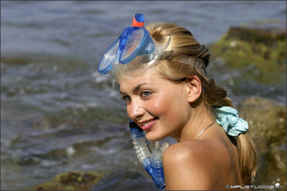 Sweet teen models naked on a rock in the ocean in snorkeling gear - #11