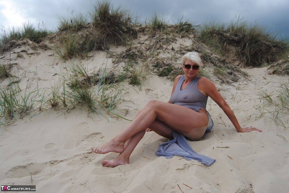 Older blonde amateur Dimonty models at the beach in see thru attire and shades - #3