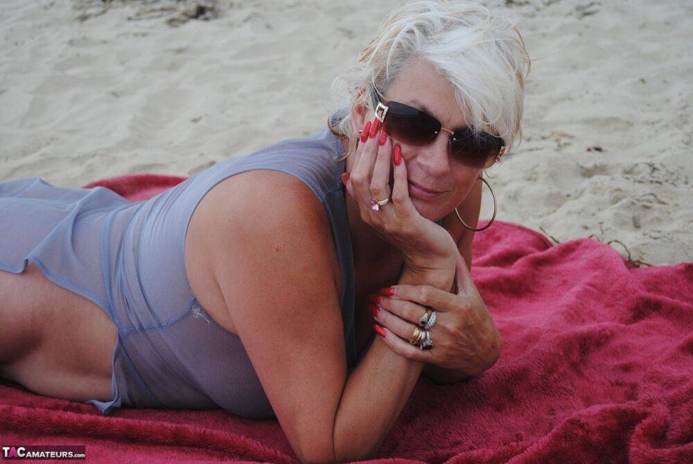 Older blonde amateur Dimonty models at the beach in see thru attire and shades - #15