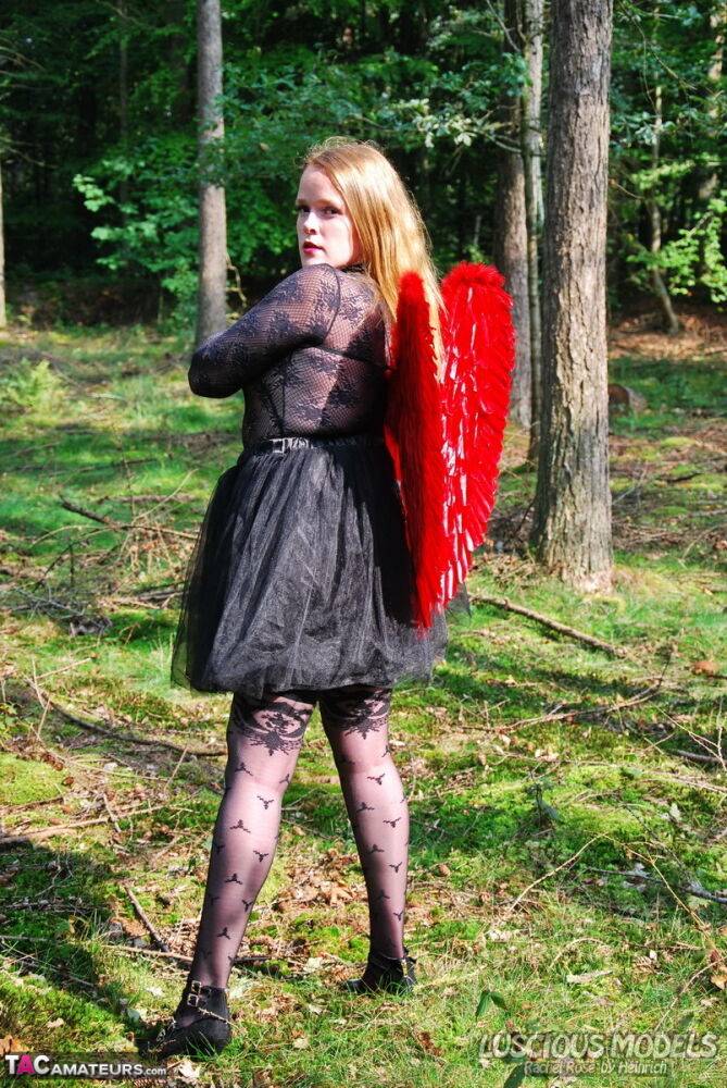 Amateur solo girl sports angel wings while modelling lingerie on a tree stump - #13