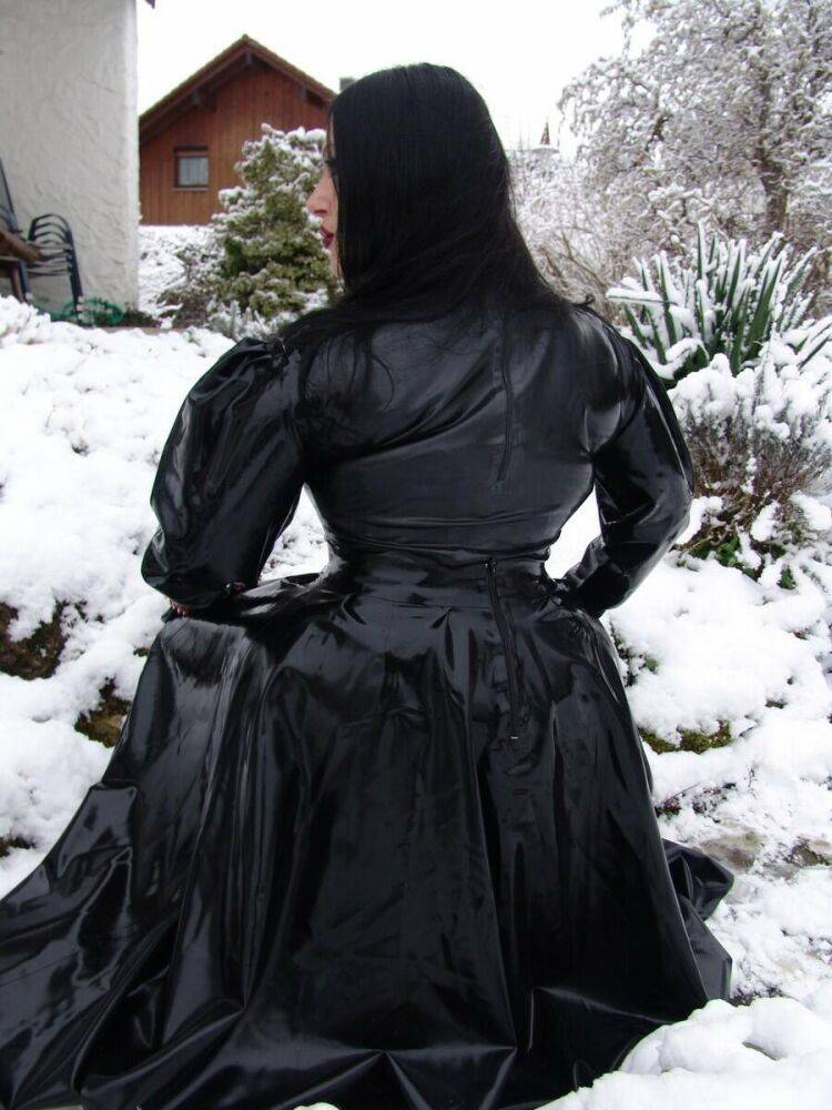 Goth woman Lady Angelina models a black latex dress on snow-covered ground - #11