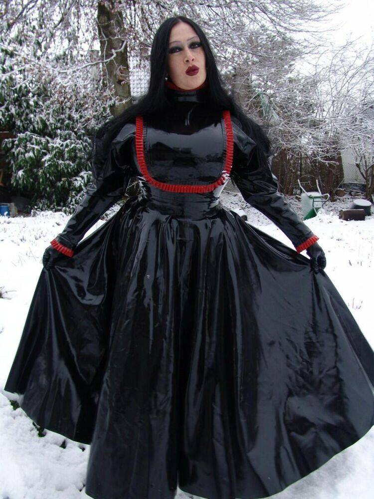 Goth woman Lady Angelina models a black latex dress on snow-covered ground - #5